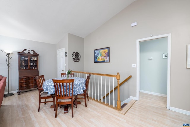 dining space with lofted ceiling and light hardwood / wood-style floors