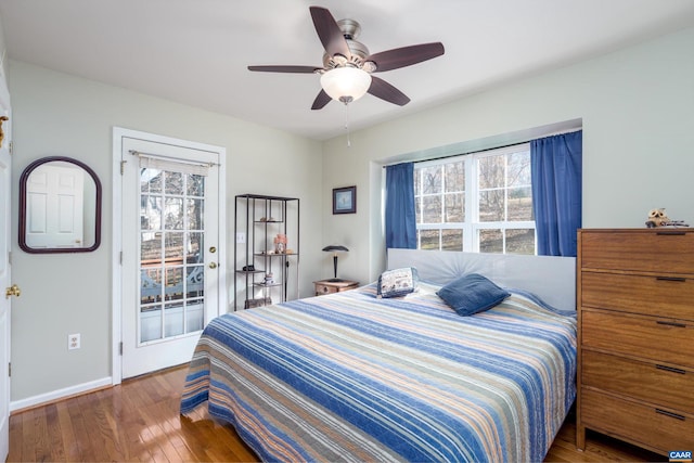 bedroom featuring dark wood-type flooring, access to exterior, and ceiling fan