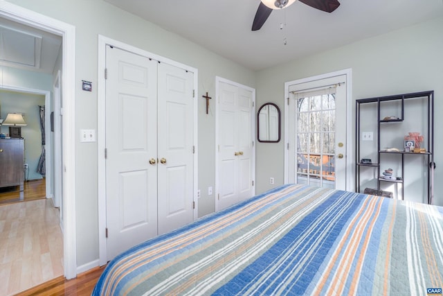 bedroom with multiple closets, hardwood / wood-style floors, and ceiling fan