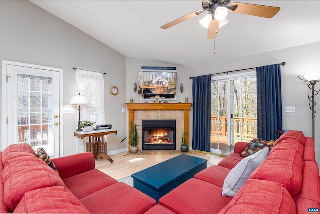 living room with vaulted ceiling, hardwood / wood-style floors, ceiling fan, and a fireplace