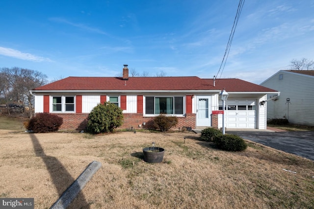 ranch-style house featuring a garage and a front yard