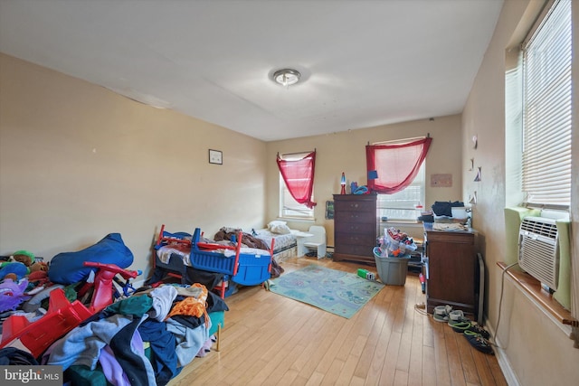 bedroom featuring cooling unit and light hardwood / wood-style flooring