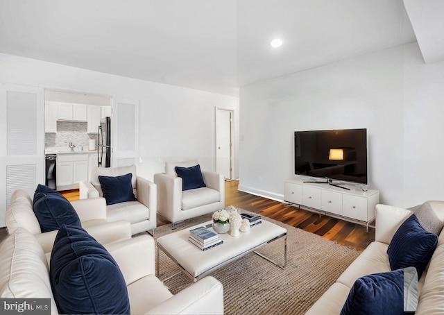 living room with sink and dark hardwood / wood-style flooring