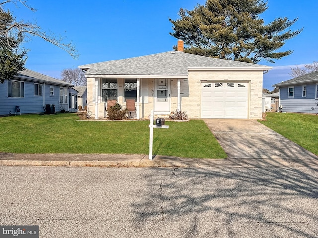 single story home with a porch, a garage, and a front yard