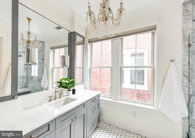 bathroom with vanity, crown molding, and a chandelier