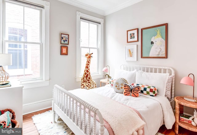 bedroom with crown molding and wood-type flooring