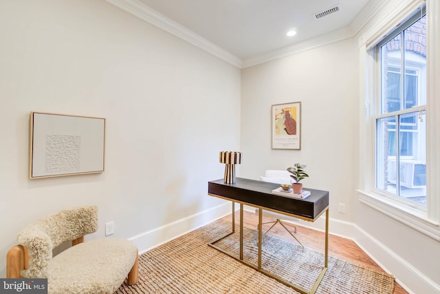 office area featuring ornamental molding, a healthy amount of sunlight, and wood-type flooring