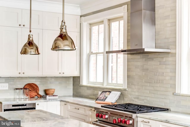 kitchen with stove, wall chimney range hood, white cabinets, and light stone counters