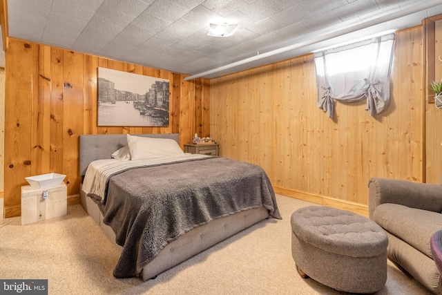 carpeted bedroom featuring wooden walls