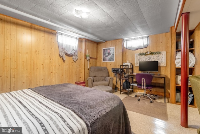 bedroom featuring wood walls