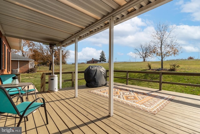 wooden terrace featuring a yard, a rural view, and grilling area