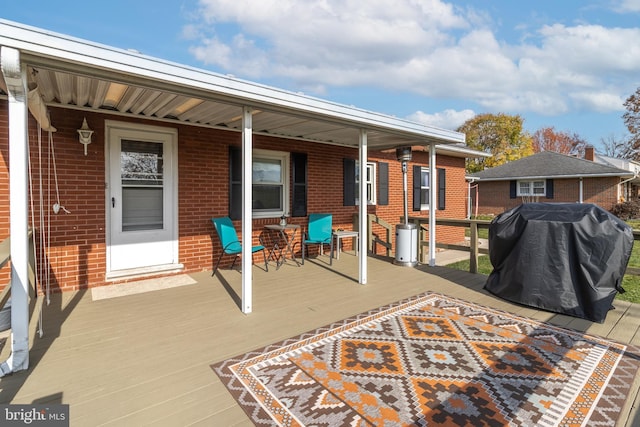 wooden terrace featuring grilling area