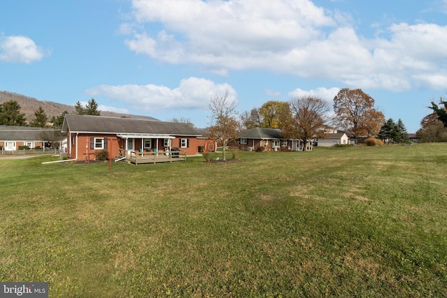 view of yard featuring a wooden deck