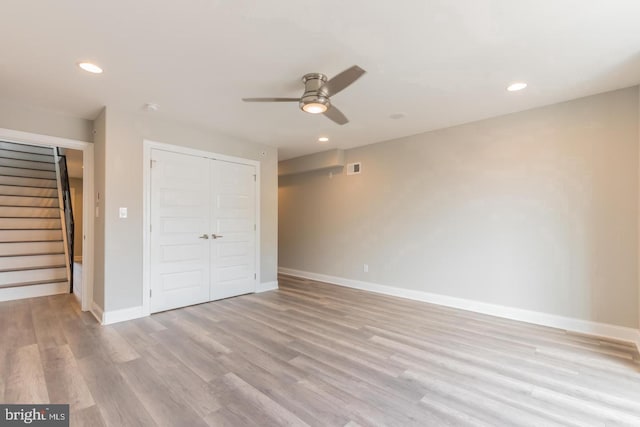 unfurnished bedroom featuring light hardwood / wood-style flooring, a closet, and ceiling fan