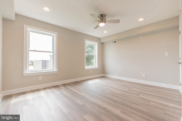 unfurnished room with ceiling fan and light wood-type flooring