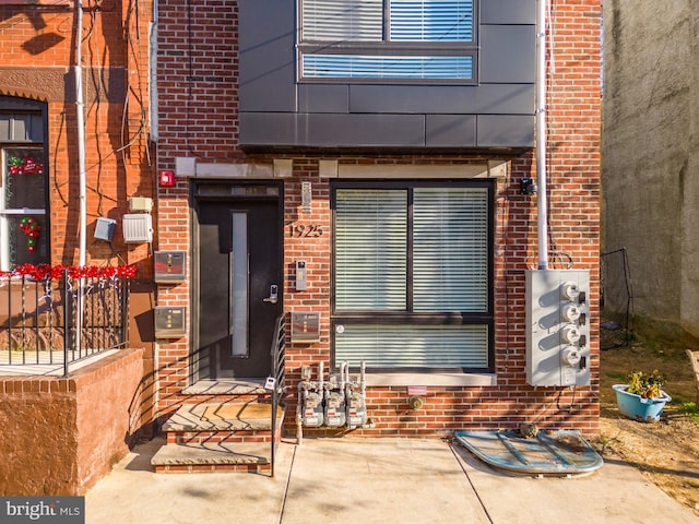 view of exterior entry featuring a patio