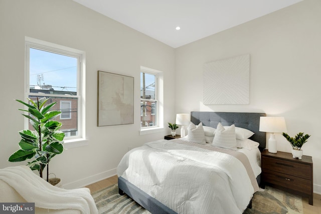 bedroom featuring hardwood / wood-style flooring and multiple windows