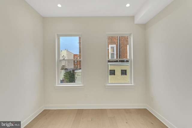 unfurnished room with a healthy amount of sunlight and light wood-type flooring