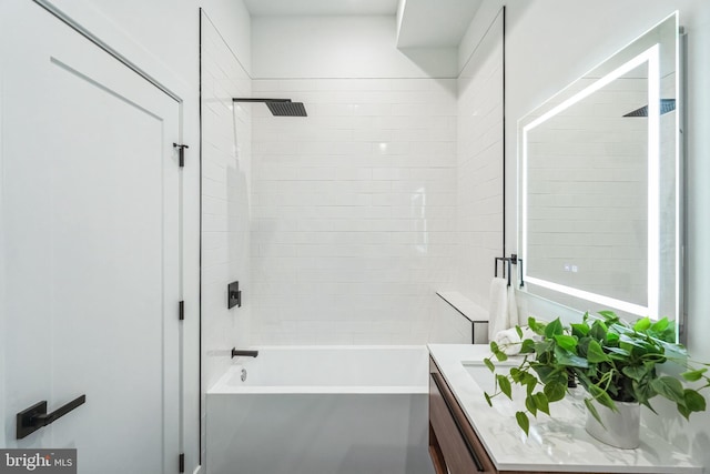 bathroom featuring vanity and tiled shower / bath combo