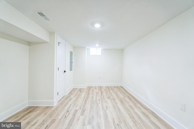 basement with light hardwood / wood-style flooring