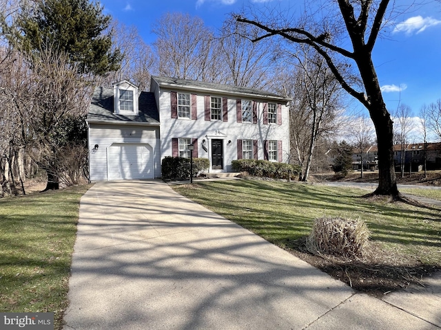 colonial home with a garage and a front lawn