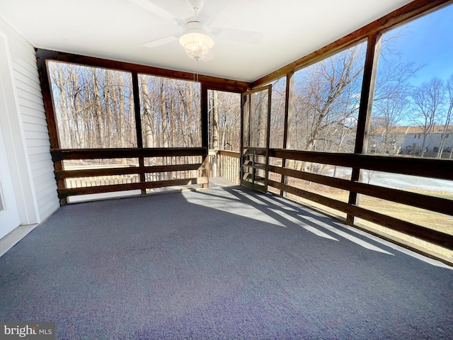 unfurnished sunroom with ceiling fan and a healthy amount of sunlight