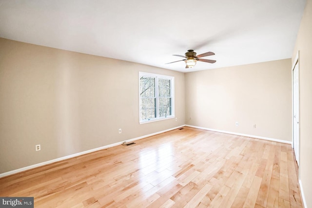 unfurnished room with ceiling fan and light wood-type flooring