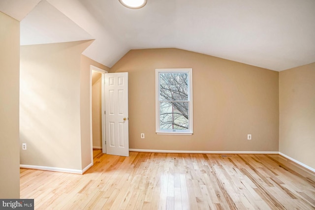 bonus room featuring lofted ceiling and light wood-type flooring