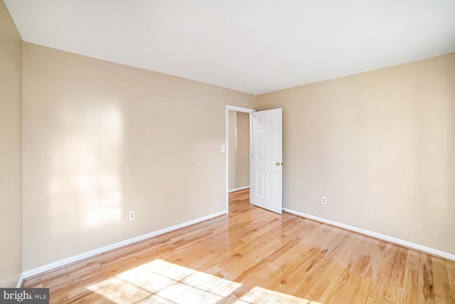 spare room featuring wood-type flooring