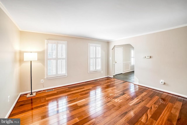 empty room featuring crown molding and dark hardwood / wood-style floors