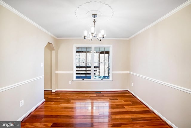 unfurnished dining area featuring a notable chandelier, crown molding, and wood-type flooring