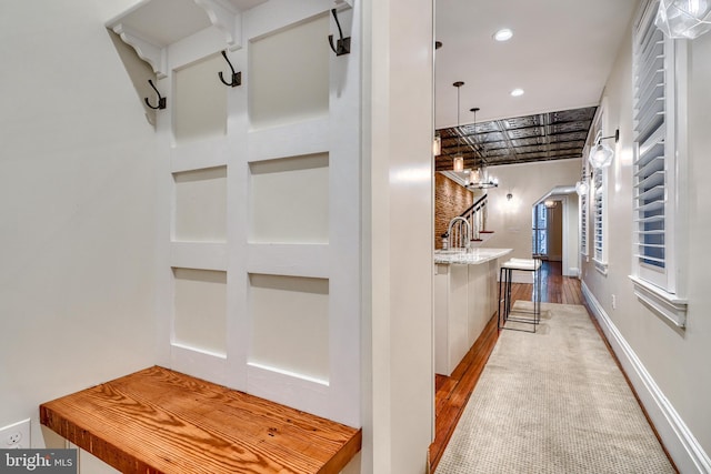 interior space with arched walkways, recessed lighting, wood finished floors, baseboards, and stairs