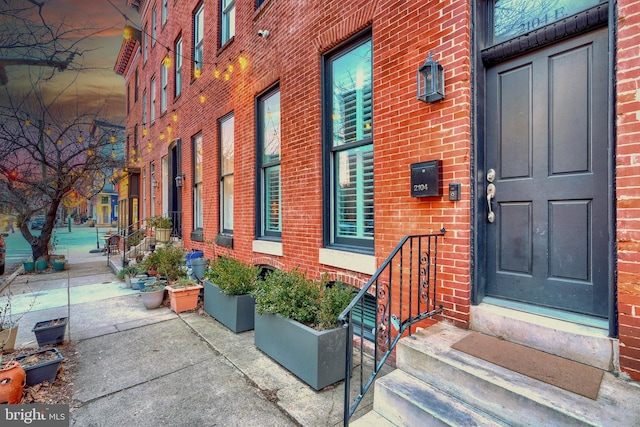 property entrance featuring brick siding