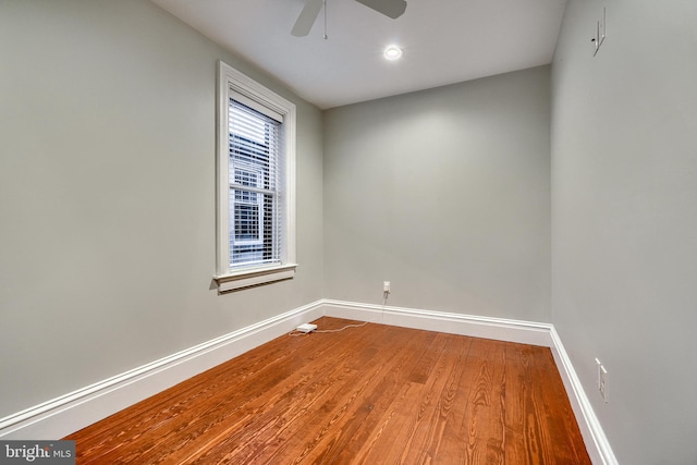 empty room with a ceiling fan, baseboards, and wood finished floors