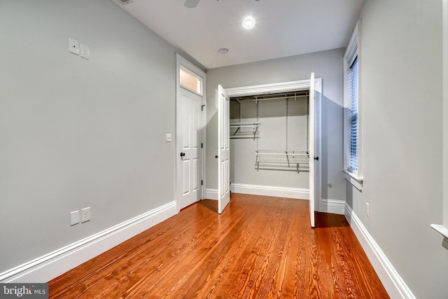 unfurnished bedroom with light hardwood / wood-style flooring and a closet