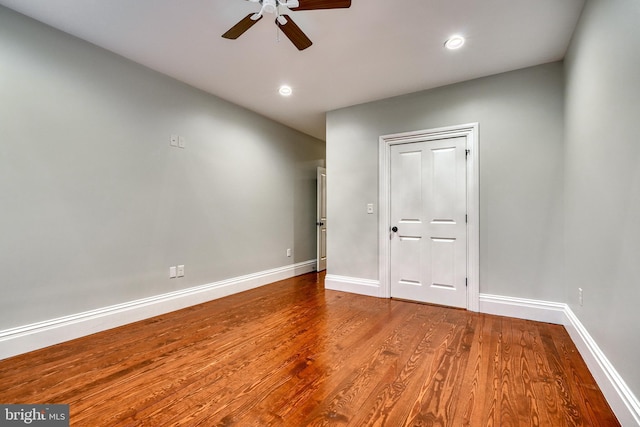 unfurnished bedroom with wood-type flooring, ceiling fan, and a closet