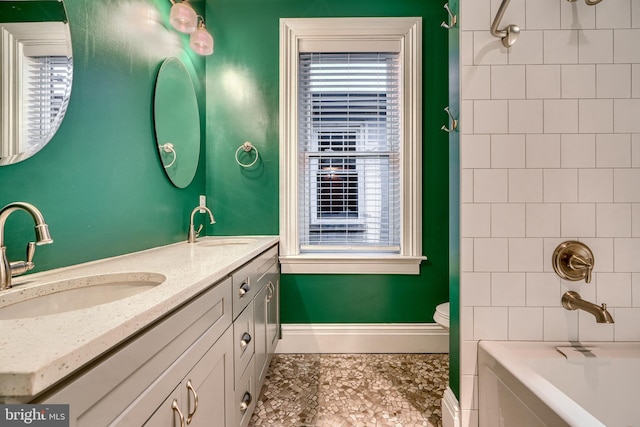 full bathroom with tiled shower / bath combo, vanity, and toilet