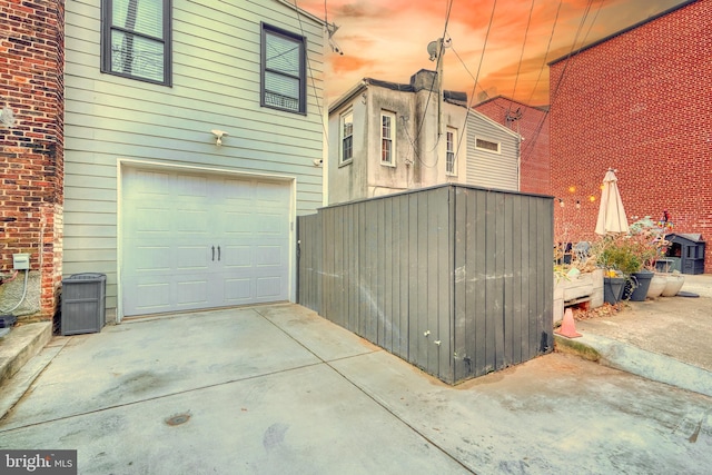 view of garage at dusk