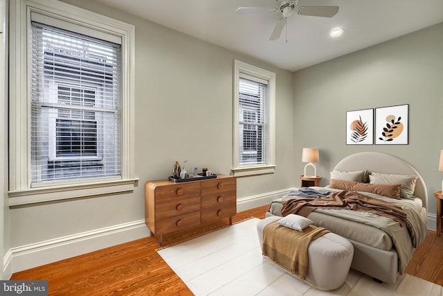 bedroom with ceiling fan and light wood-type flooring