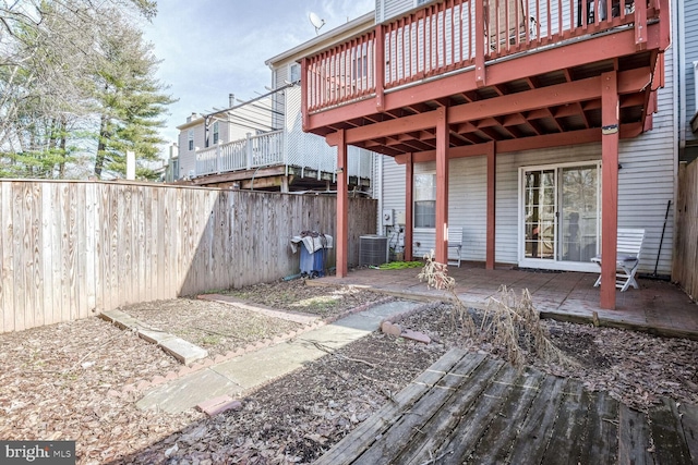 exterior space featuring a wooden deck and central AC