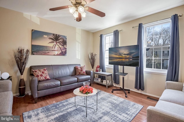 living room with hardwood / wood-style floors and ceiling fan