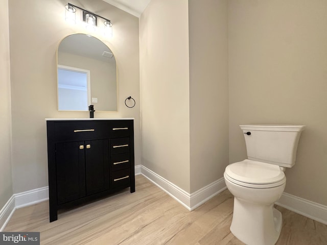 bathroom featuring vanity, toilet, and wood-type flooring