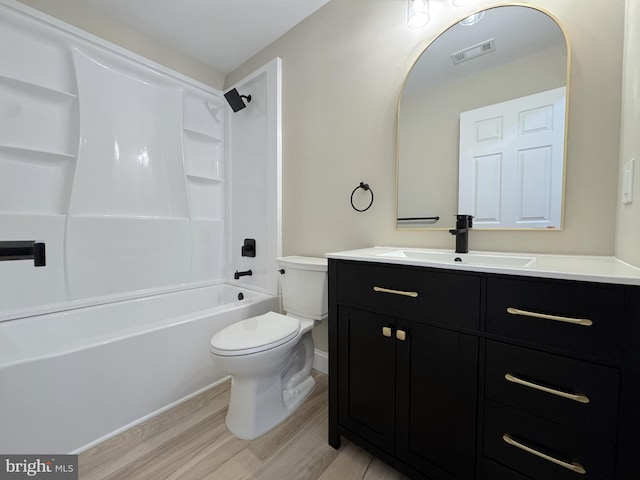 full bathroom with vanity, hardwood / wood-style flooring, shower / tub combination, and toilet