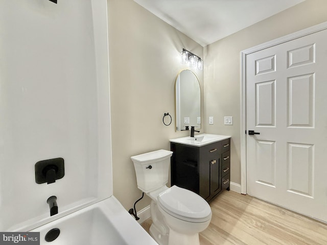 bathroom featuring vanity, hardwood / wood-style floors, and toilet