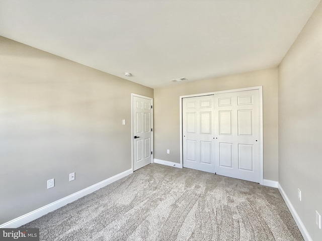 unfurnished bedroom featuring a closet and carpet