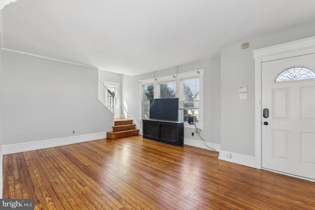 foyer entrance with stairs, wood-type flooring, baseboards, and a healthy amount of sunlight