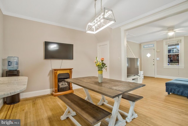 dining area featuring ornamental molding, ceiling fan, and light hardwood / wood-style flooring