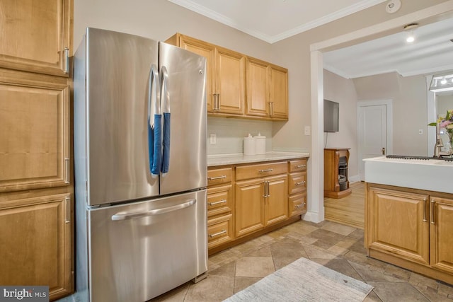 kitchen featuring ornamental molding, stainless steel fridge, and decorative backsplash