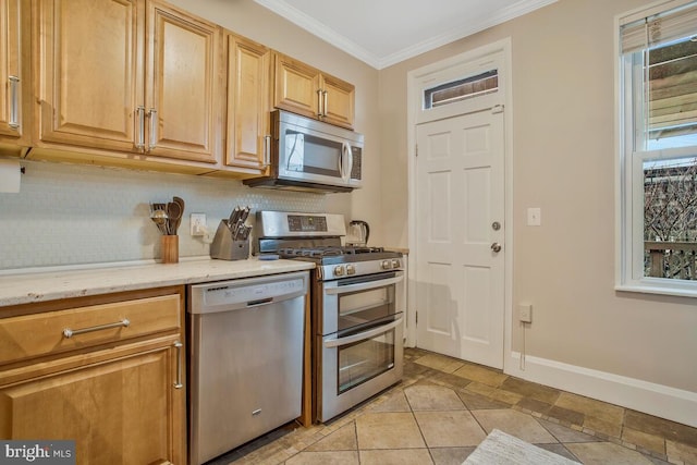 kitchen with ornamental molding, stainless steel appliances, plenty of natural light, and backsplash