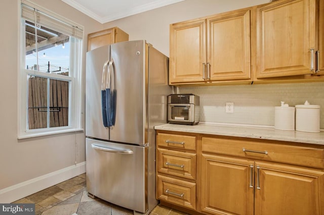 kitchen featuring ornamental molding, stainless steel fridge, and decorative backsplash